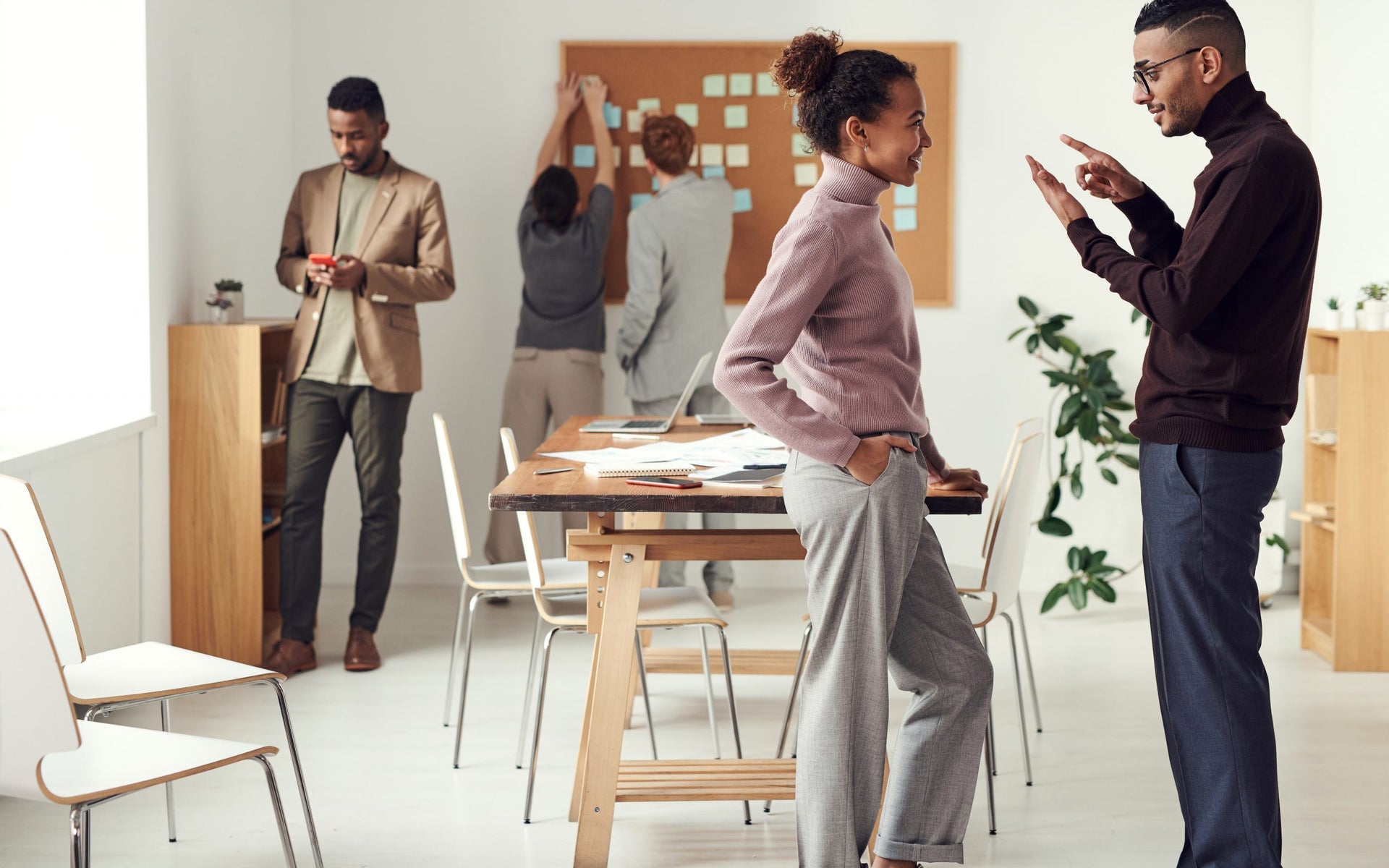 A group of workers collaborate in a co-working space